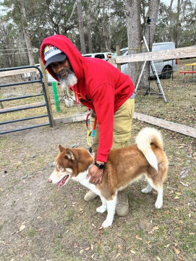 dog park with a man and a dog.